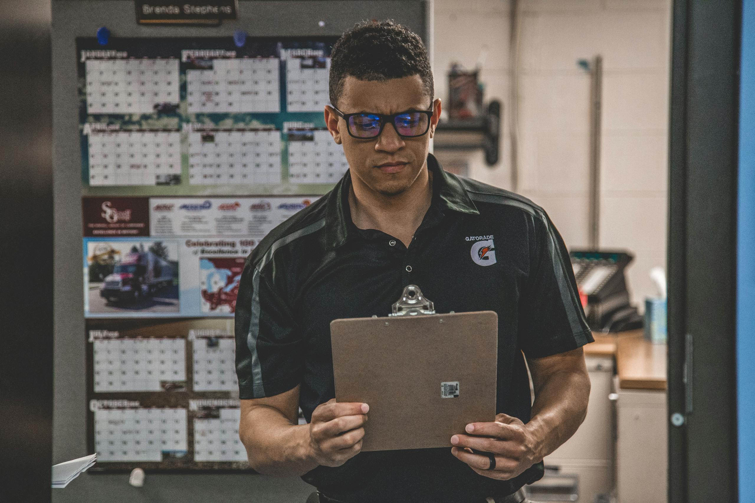 Man Holding Clipboard Inside Room